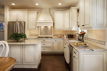 Antique white and brown kitchen with vintage style granite countertops